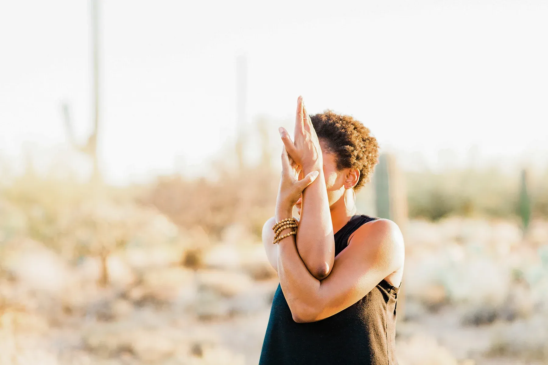 Person practicing mindfulness outdoors in a desert, highlighting Mental Health Training for Community Groups & NGOs to promote well-being and self-care.